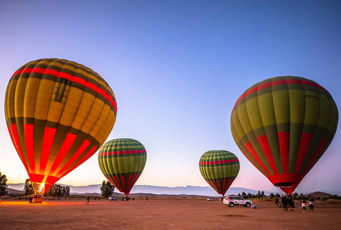 Hot air balloon floating above Marrakech at sunrise