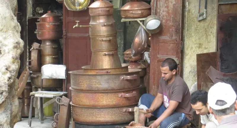 Copper and brassware displayed in a Fes medina workshop