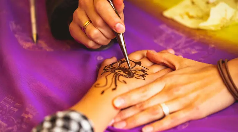 Intricate henna patterns painted on a hand