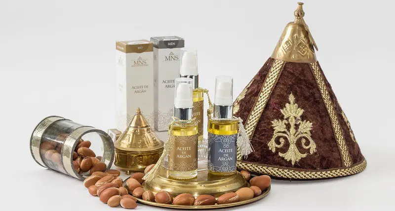 Argan nuts and oil bottles beside argan trees in southwest Morocco
