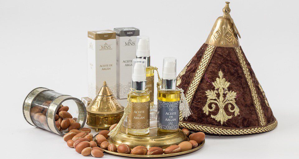 Argan nuts and oil bottles beside argan trees in southwest Morocco