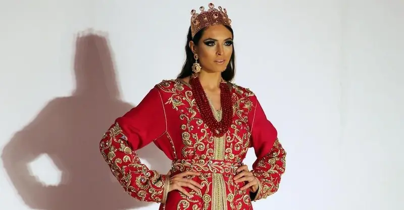 A model show red Takchita dress