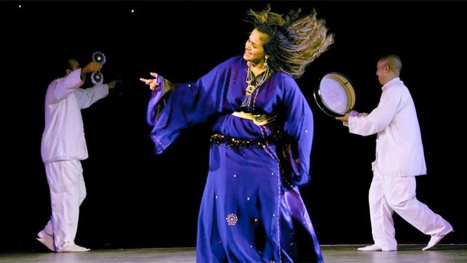 Performers in traditional dress during a Moroccan folk dance