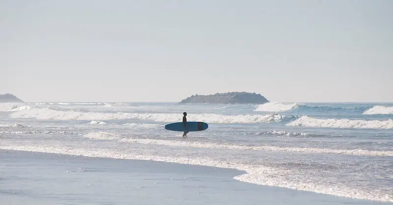 Long board surfer stand on the beach