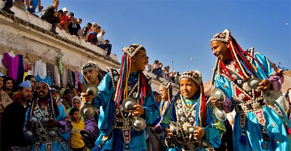 Gnawa musicians performing with drums and castanets