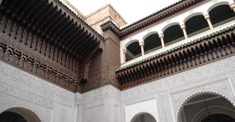 Horseshoe arches and carved plaster inside a Moroccan palace