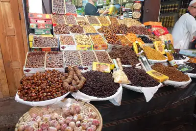 Market stall piled with dates, dried figs, apricots and nuts