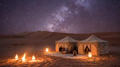 Luxury desert camp tents under a starry Sahara night sky