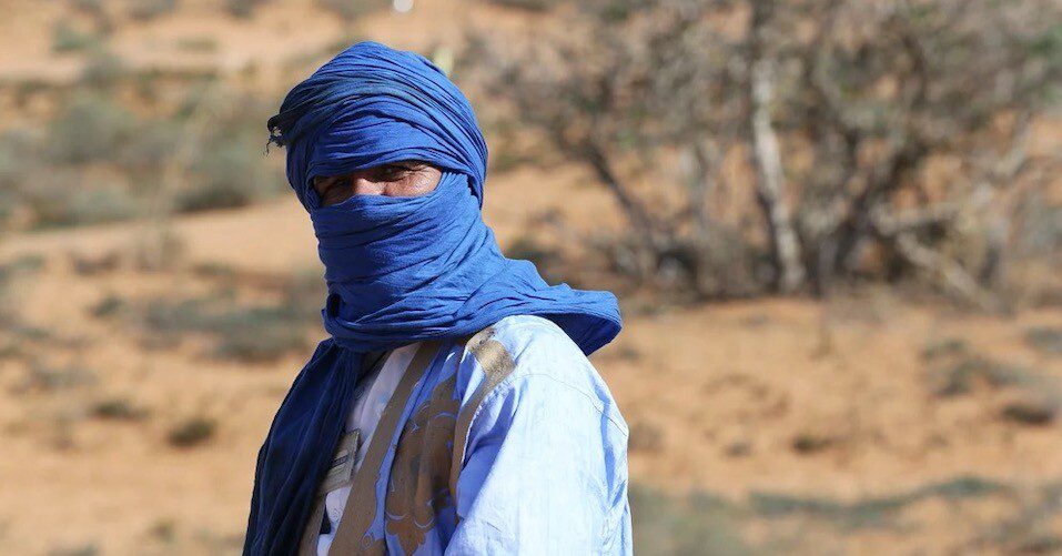 A man cover his face with blue scarf  A man cover his face with blue scarf