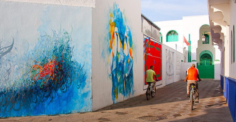 Two young men riding bikes in the medina