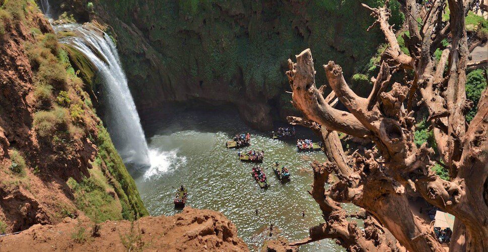 People have fun in waterfall and its ponds