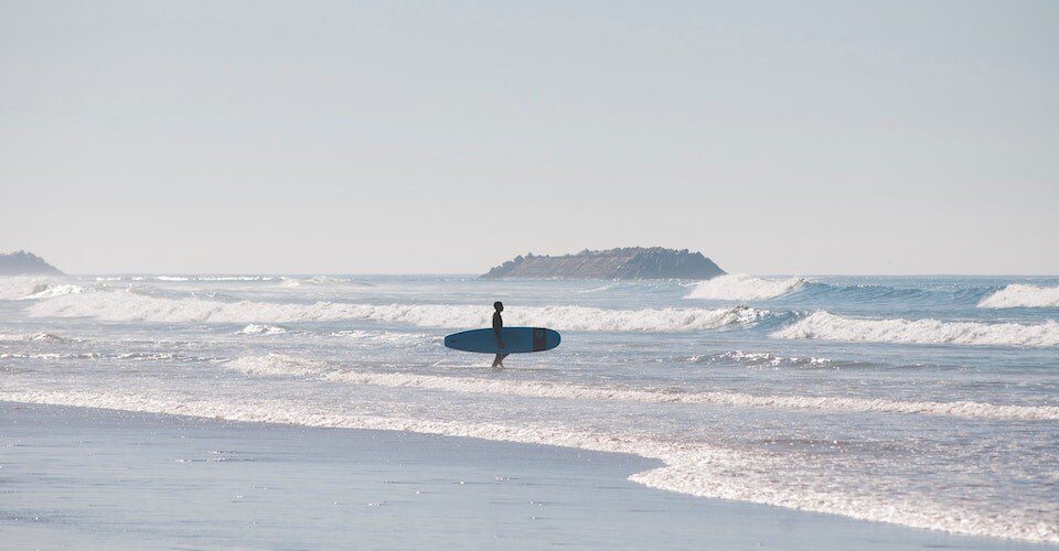 Long board surfer stand on the beach